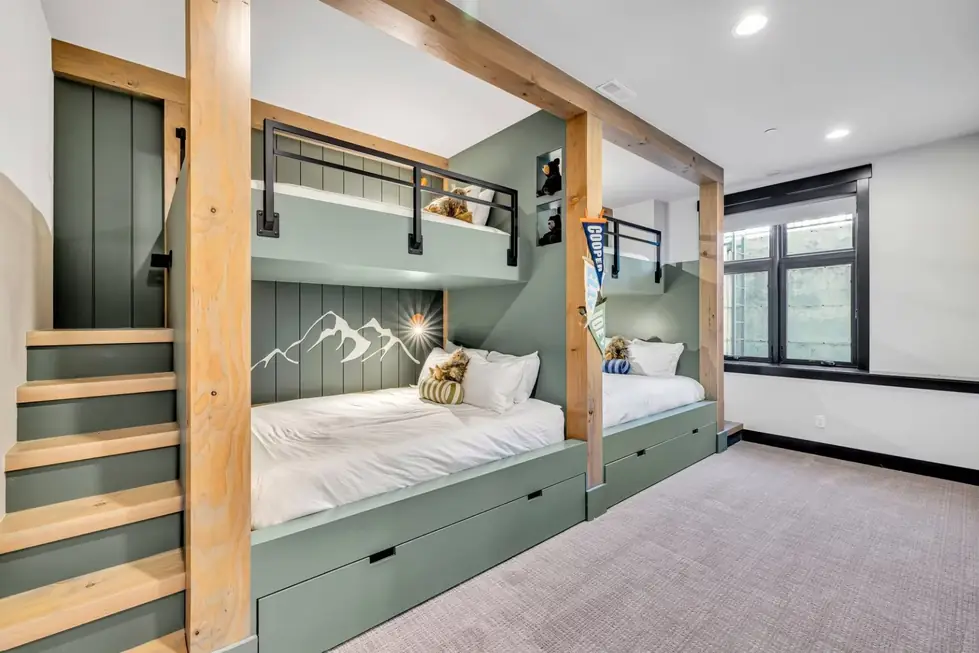 Built-in sage-green bunk beds with natural timber posts, painted, stained and clear coated