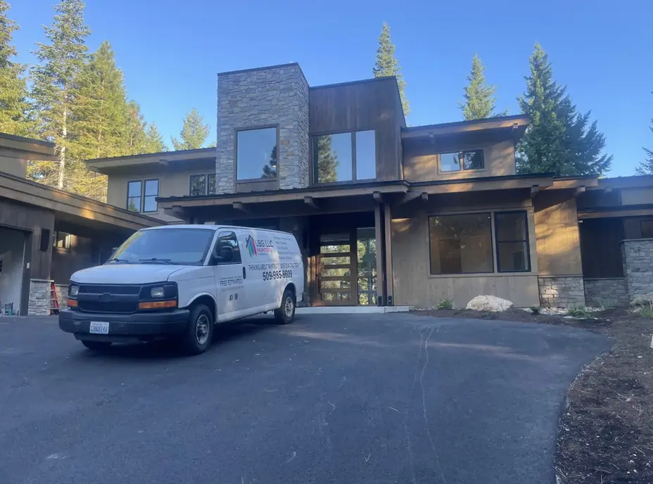 The lettered UBG van parked at Ruby King, a modern stone and cedar home in the pines